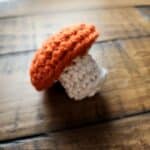 This free tiny mushroom crochet pattern is great for things like keychains, garlands, or even just a cute little gift for a friend or loved one. It is very simple, and can be made in less than an hour. this pattern is almost no sew. The only sewing step is closing the bottom of the stem.