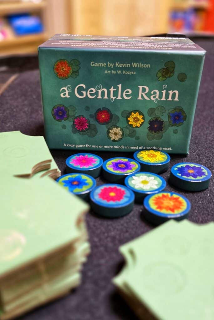 A Gentle Rain is a quick little puzzlely board game that I just love playing to wind down after a long day. It is so easy you could do it while listening to your favorite music or audiobook. It is the perfect mental reset game. To put it simply this easy solo game is a great way to relax.